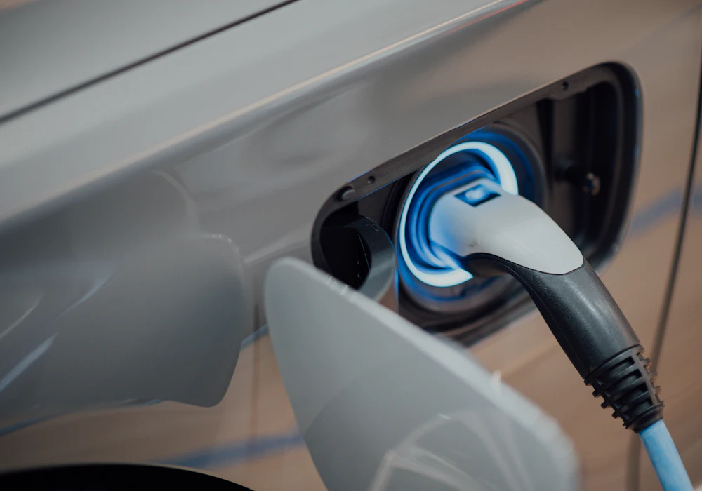 A charging connector plugged into the charge port of an electric car